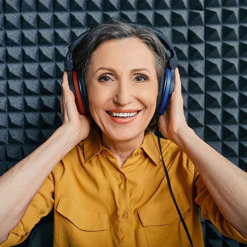 Woman in a hearing booth getting her hearing tested