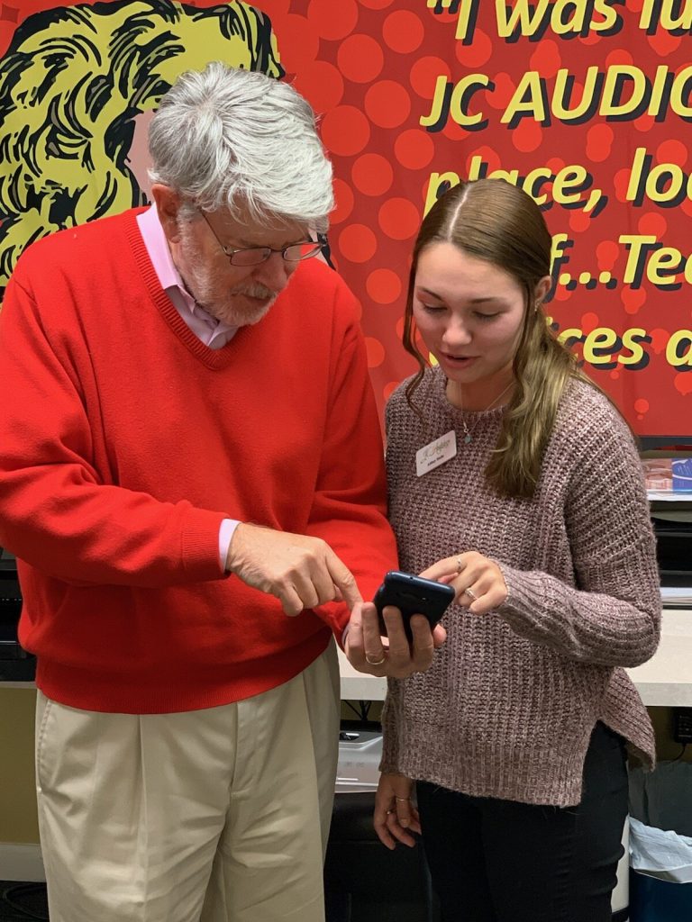 JC Audiology’s Audiology Assistant, Abbey Stohs, shows an android user who wears hearing aids how he can stream his phone calls, voice mails and music from the smartphone to his hearing aids.